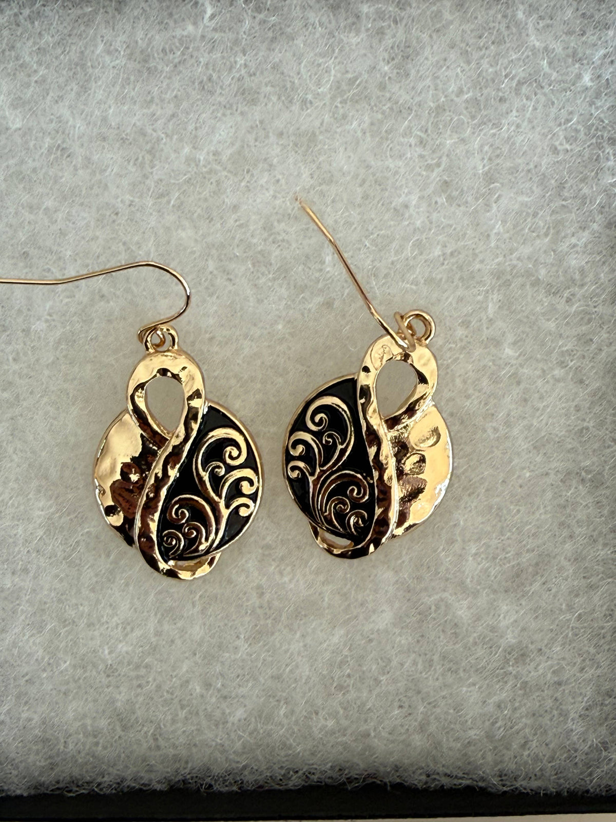 Close view of the hammered gold infinity earrings