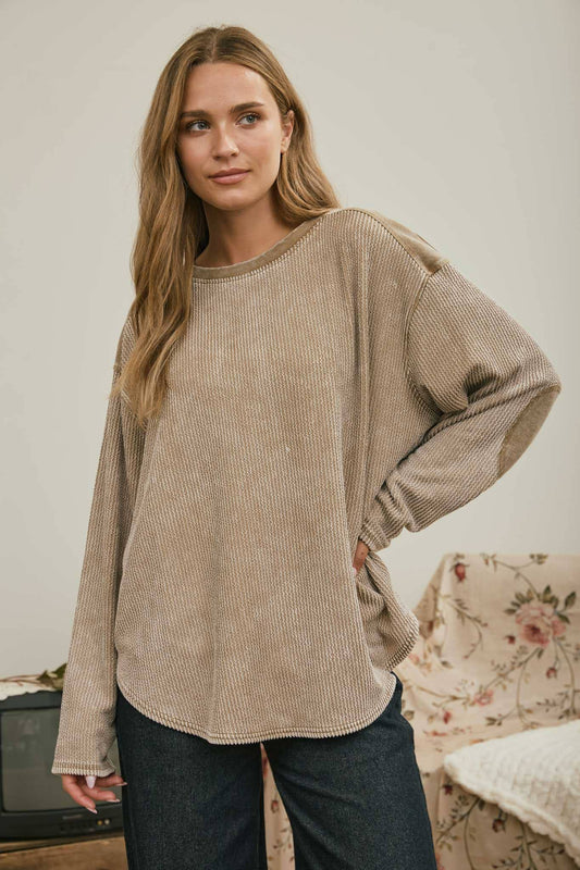 Front view of the brown boxy top with hand on hip