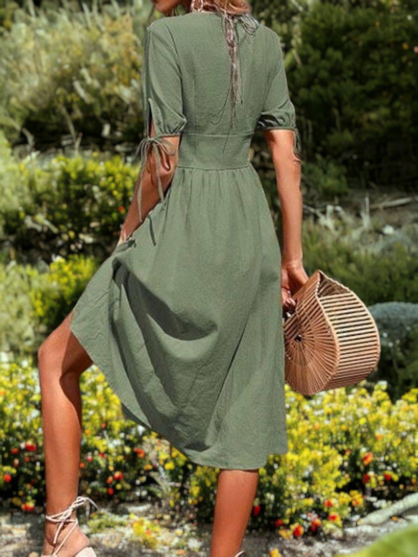 Back view of the green midi dress showing the tie-back neck