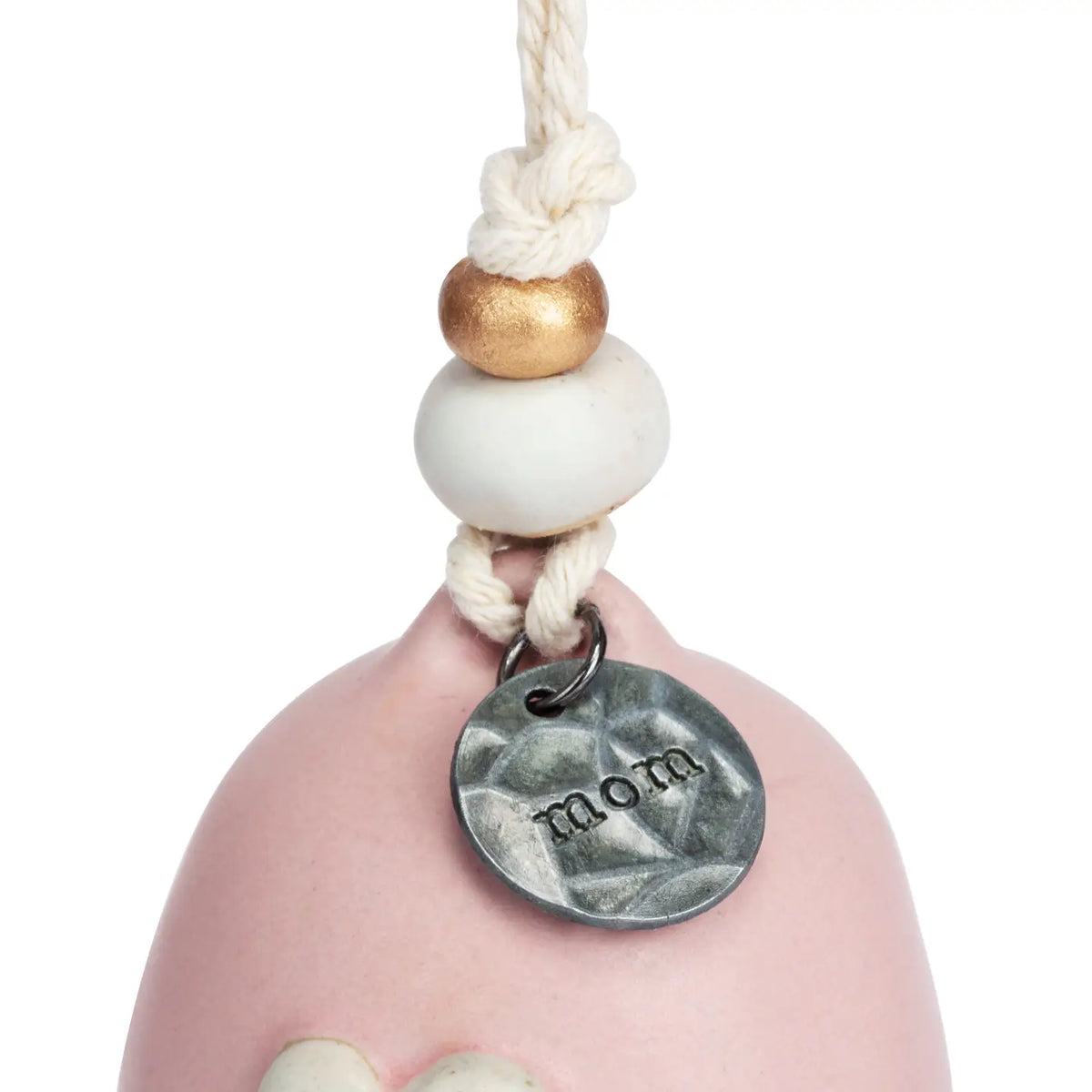 Close-up of the metal mom tag on the pink Mini Inspired Bell