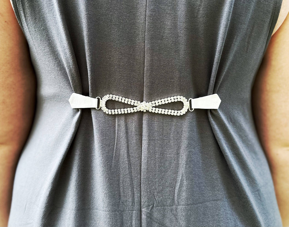 Close-up of the rhinestone clip gathering the gray dress at the back waist