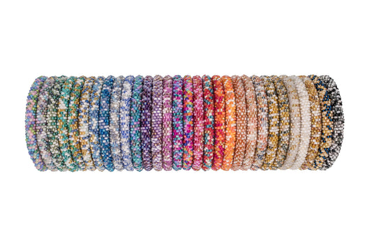 Row of assorted multicolor roll-on bracelets standing on edge