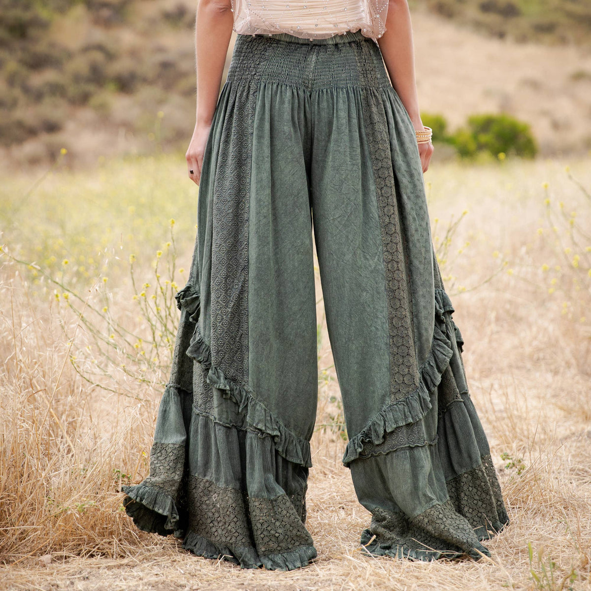 Back view of the basil mineral wash pants with a smocked waist and lace panels
