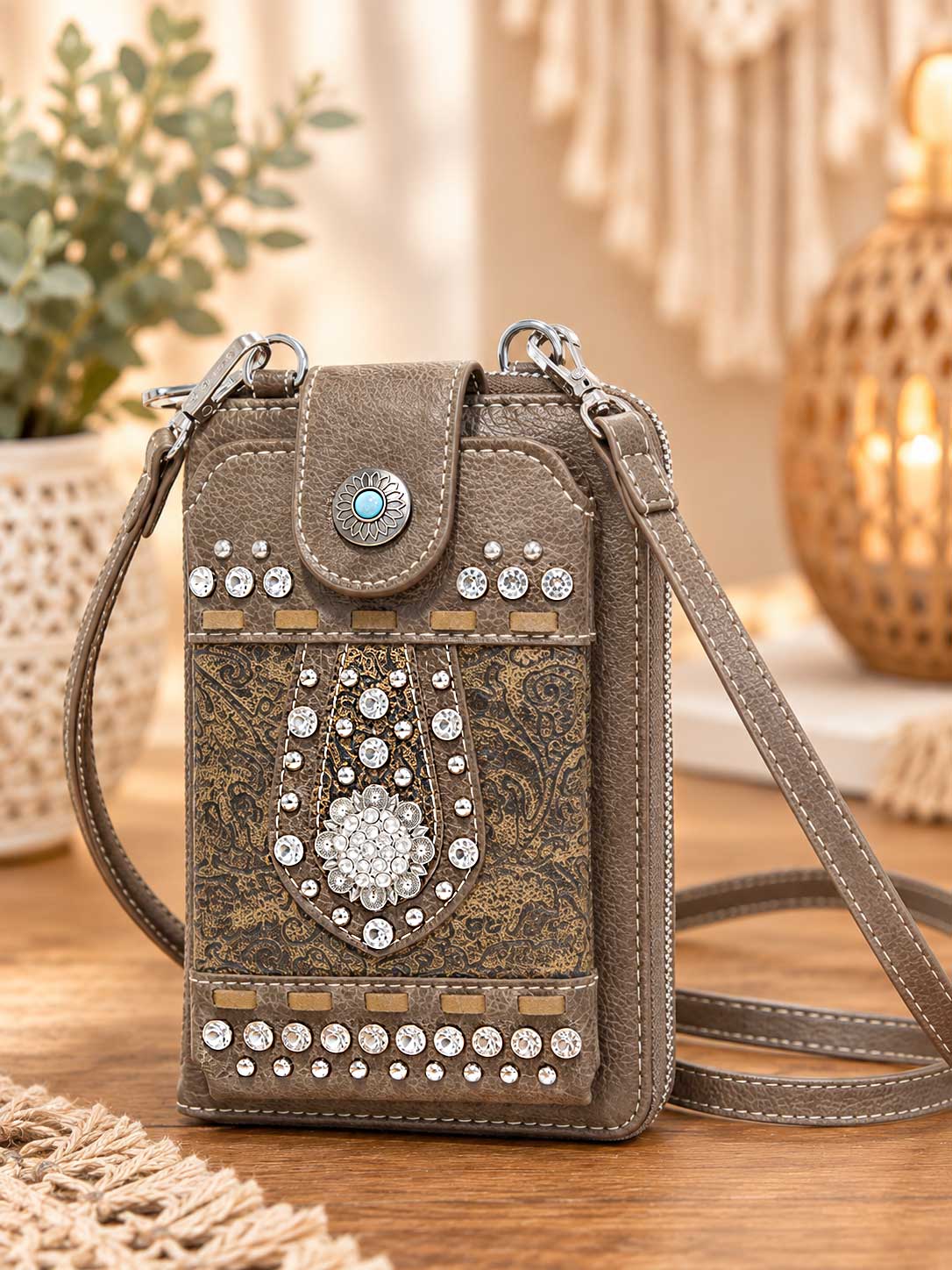 Brown studded crossbody phone wallet with silver studs, crystals and a turquoise-style floral clasp; this listing is black