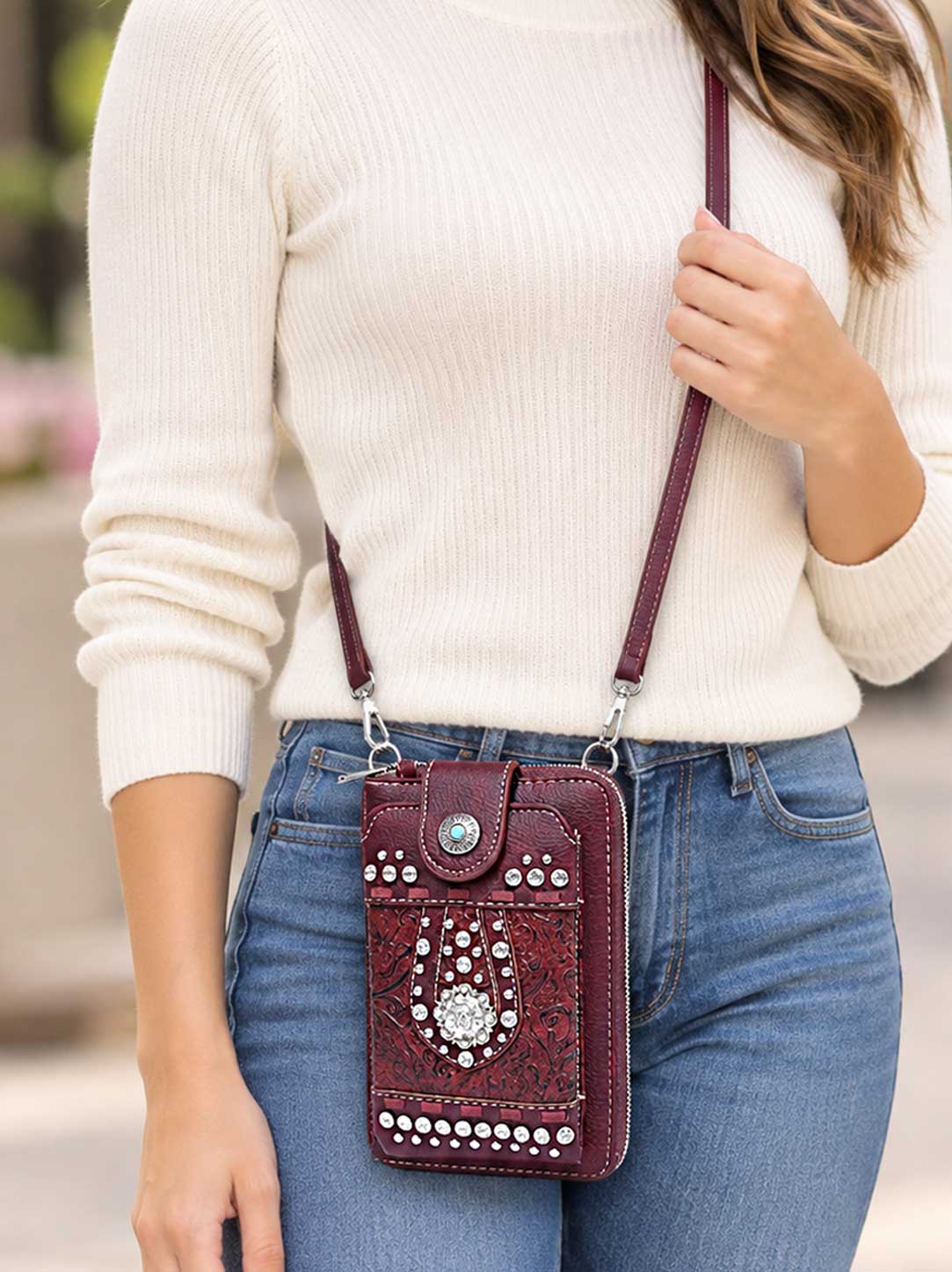 Model wearing the burgundy studded phone wallet crossbody