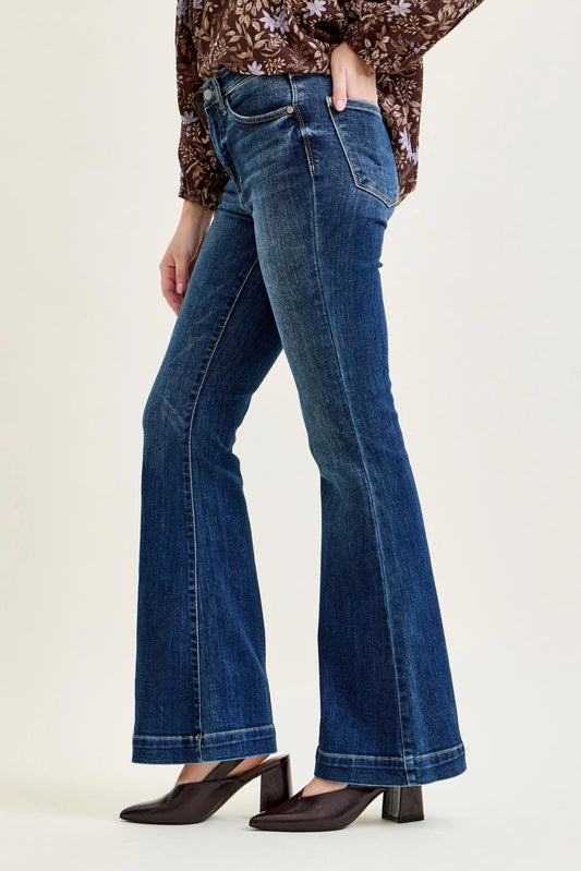 Side view of dark wash Judy Blue high-rise trouser flare jeans worn with brown heels