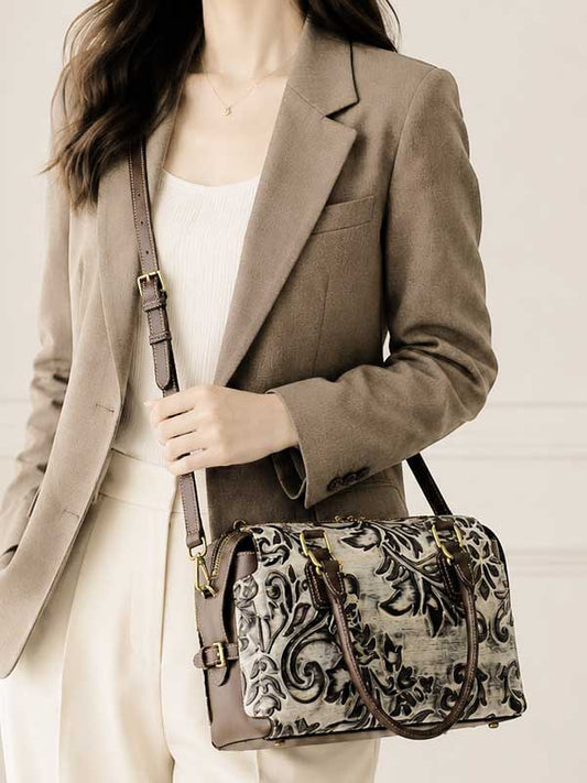 Model carrying the Glory tooled leather satchel on the shoulder