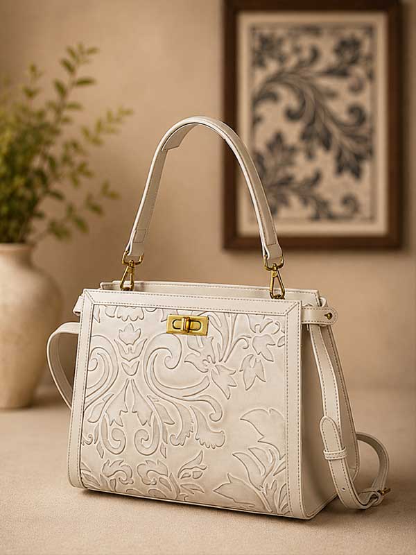 Mila satchel shown in a cream colorway from the front; this listing is chestnut brown