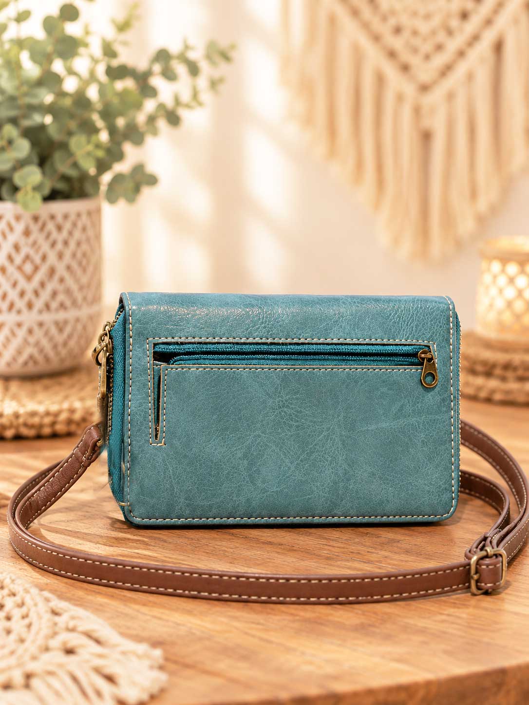 Back view of the embroidered medallion phone wallet in turquoise showing the zip pocket