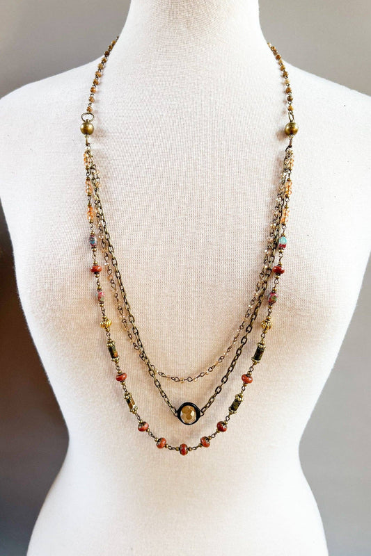 Justina red jasper necklace worn in layers on a display bust