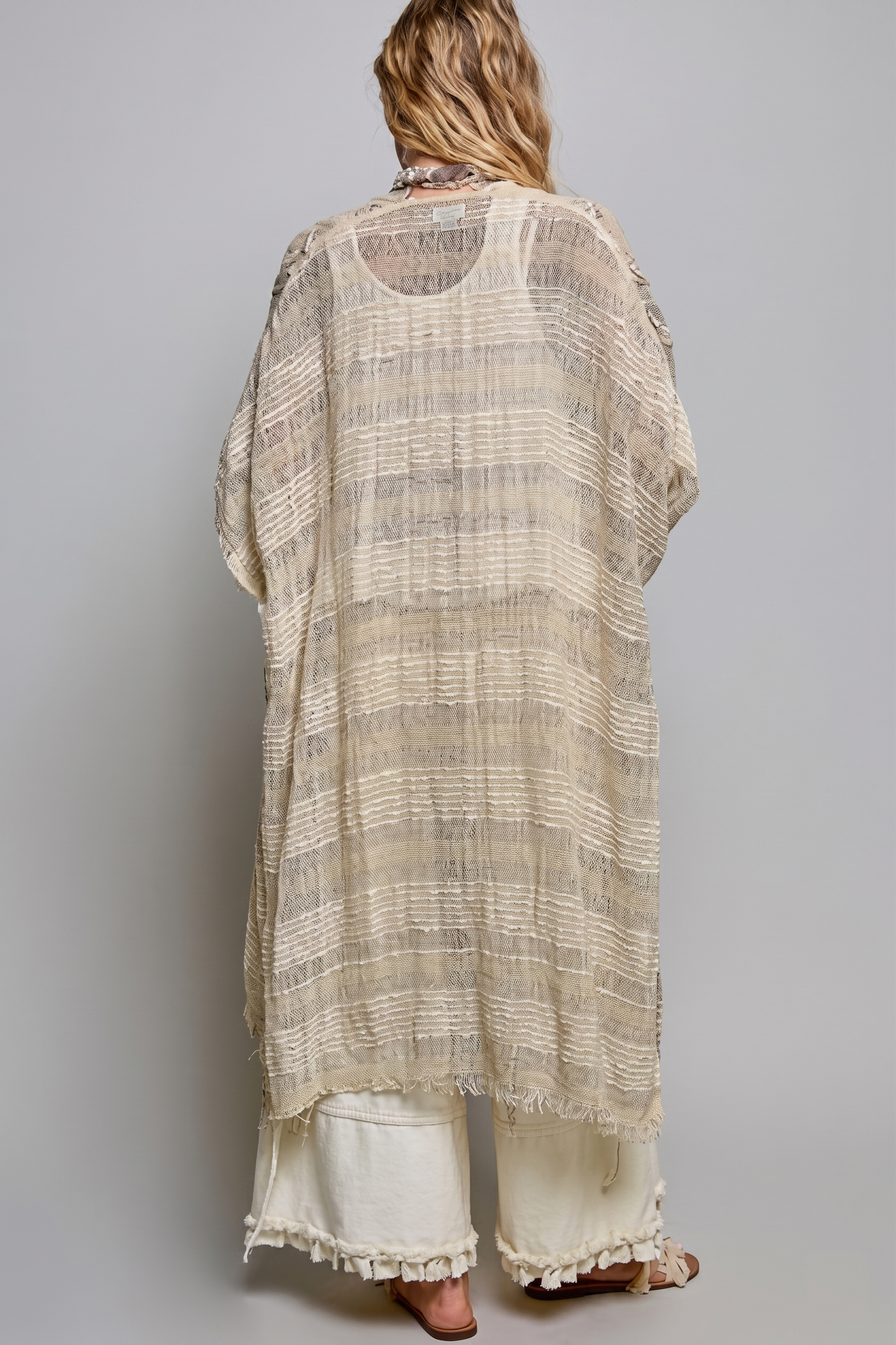 Back view of natural open-weave fringed boho kimono duster with striped texture