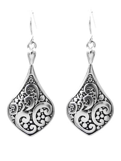 Close view of the scrolling filigree pattern on the antique silver earrings