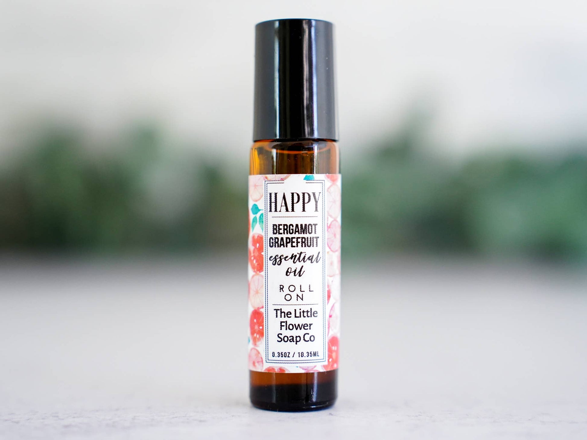 Happy bergamot and grapefruit essential oil roll-on in a glass bottle for everyday aromatherapy