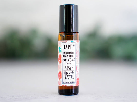 Happy bergamot and grapefruit essential oil roll-on in a glass bottle for everyday aromatherapy