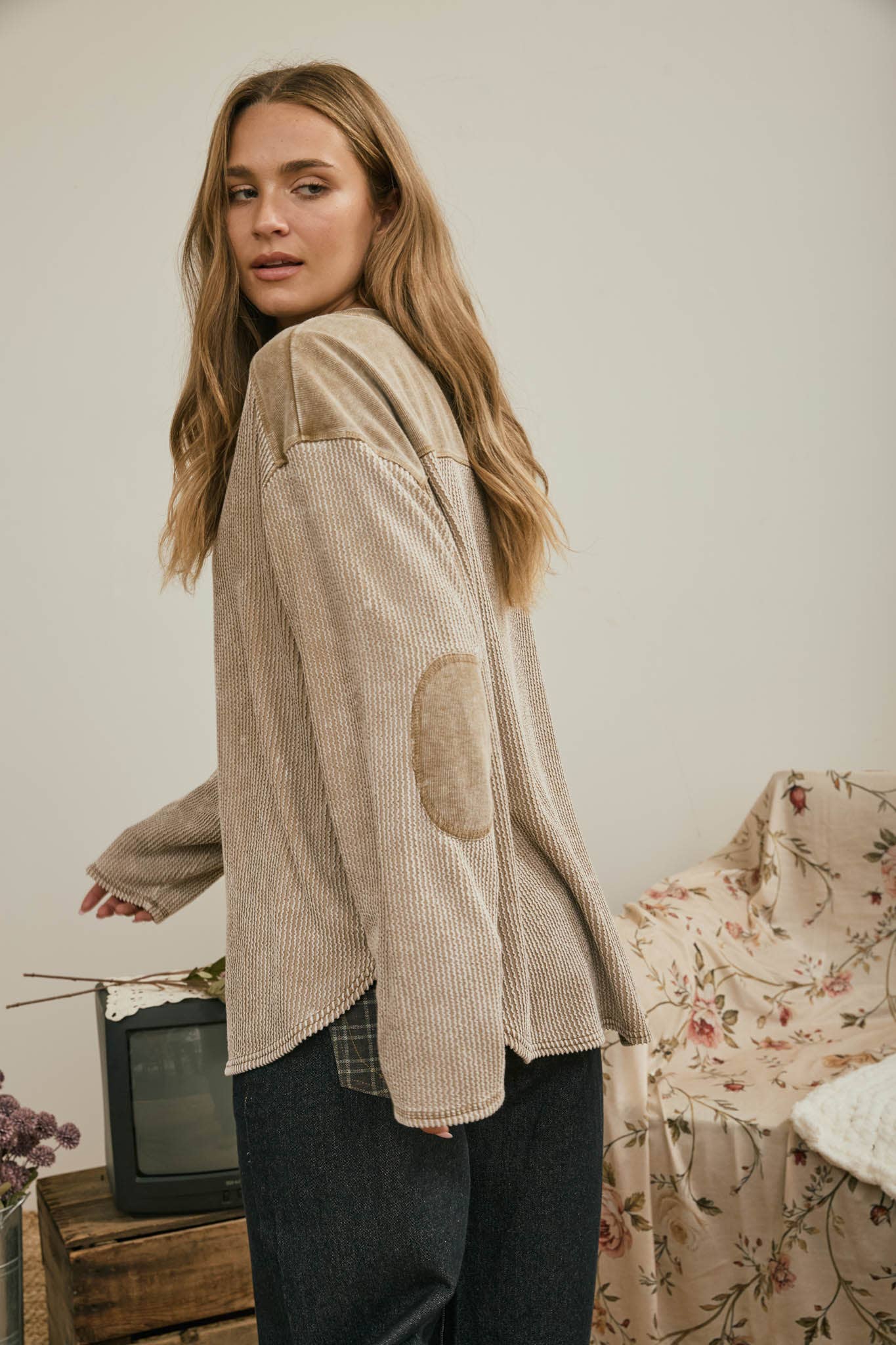 Angled back view of the brown washed knit top
