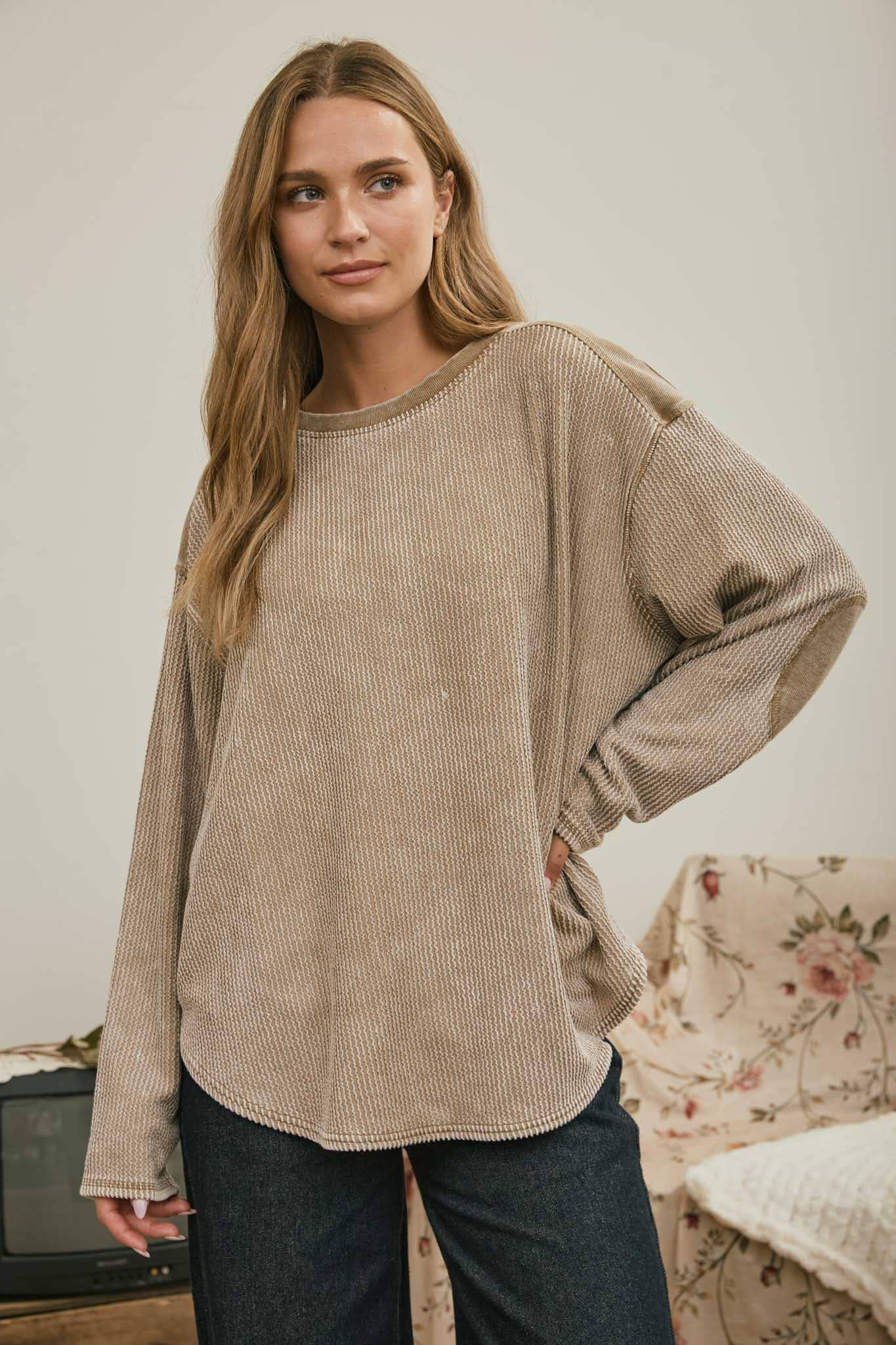Front view of the brown boxy top with hand on hip