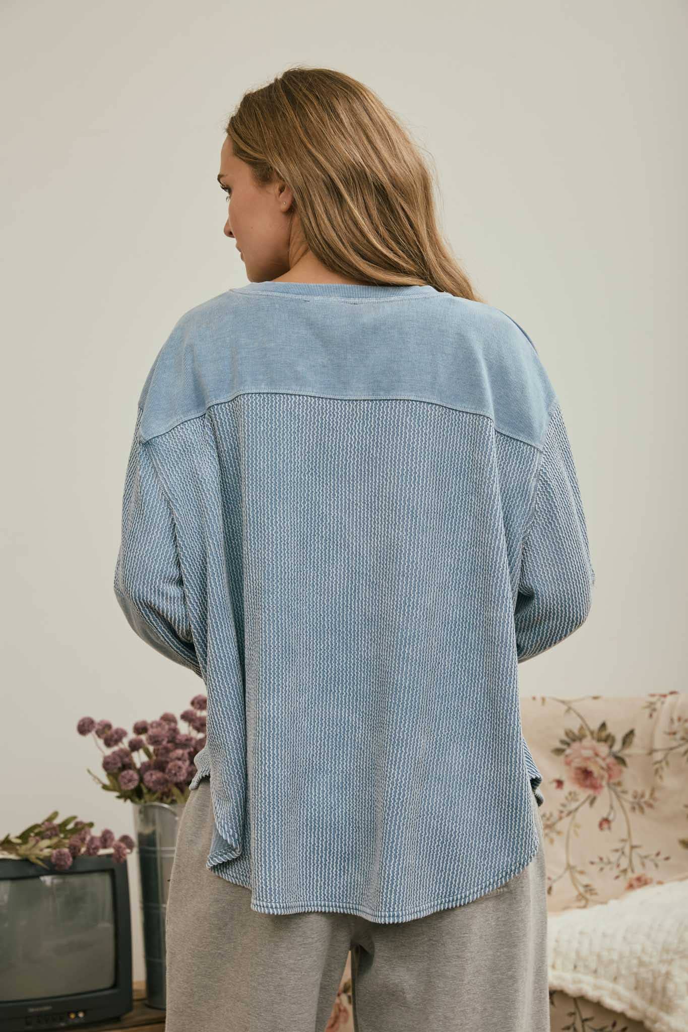 Back view of the light denim boxy knit top