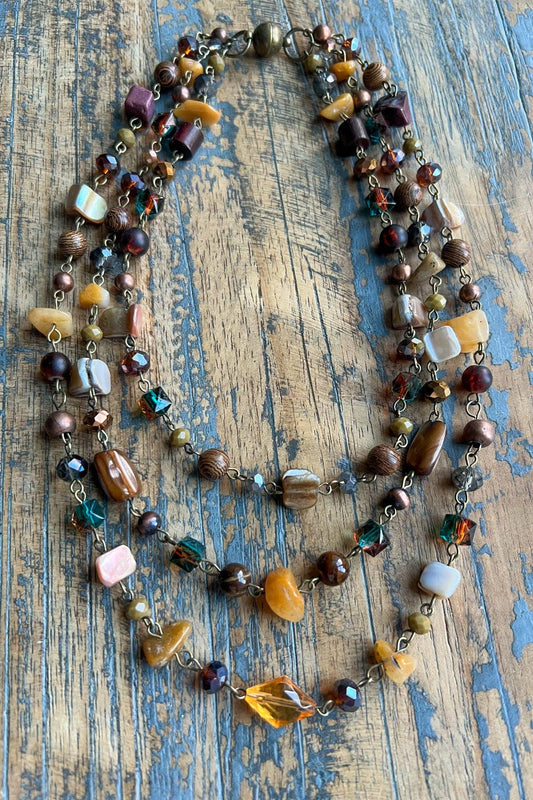 Rachel necklace with layered strands of amber, brown and neutral stone beads