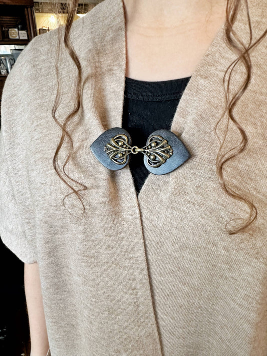 This style in the slate blue-gray colorway closing a knit cardigan; color example, this listing is black