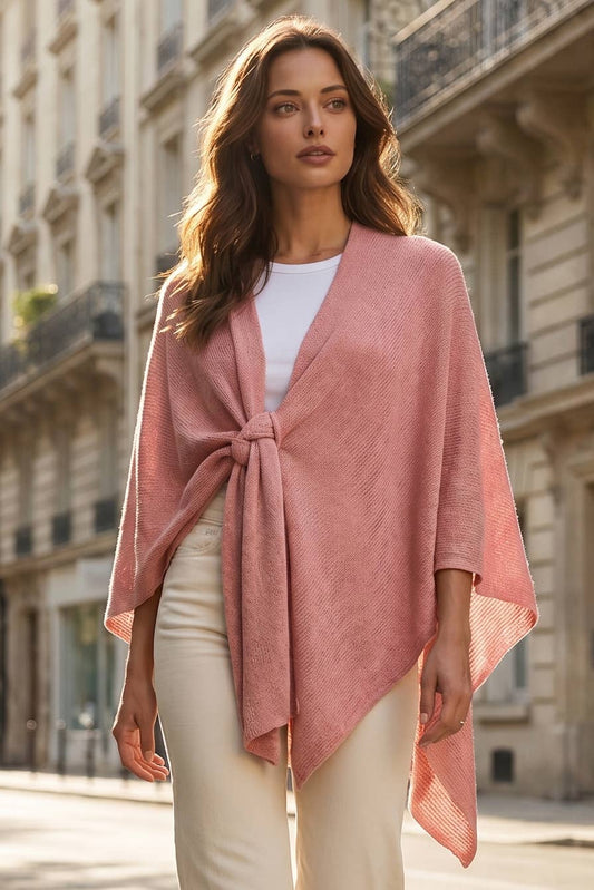 Model wearing a desert blush sweater knit poncho wrap, front view, drape open over black pants
