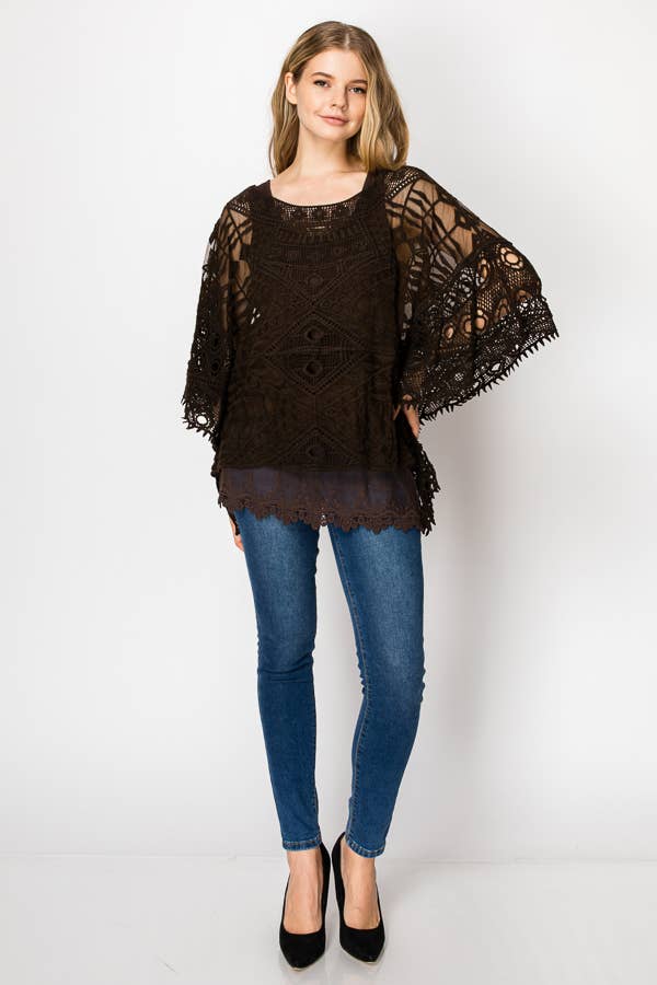 Dark brown geometric crochet lace poncho top over a grey slip, front view