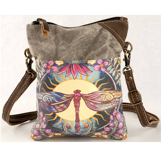 Waxed canvas crossbody passport bag in olive taupe with a printed dragonfly panel in blue, coral and gold, shown with the strap laid across