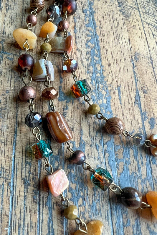 Close view of the Rachel necklace beads in amber, brown, pink and green
