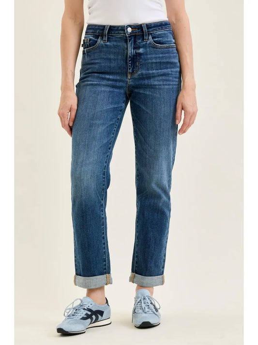 Front view of medium indigo Judy Blue Billie boyfriend jeans with rolled cuffs and sneakers