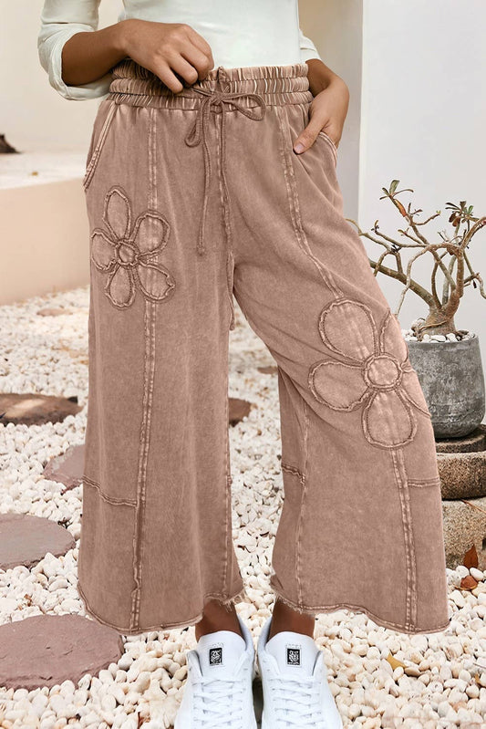 Buckskin mineral wash terry knit cropped wide leg pants with floral patches, front view with white sneakers