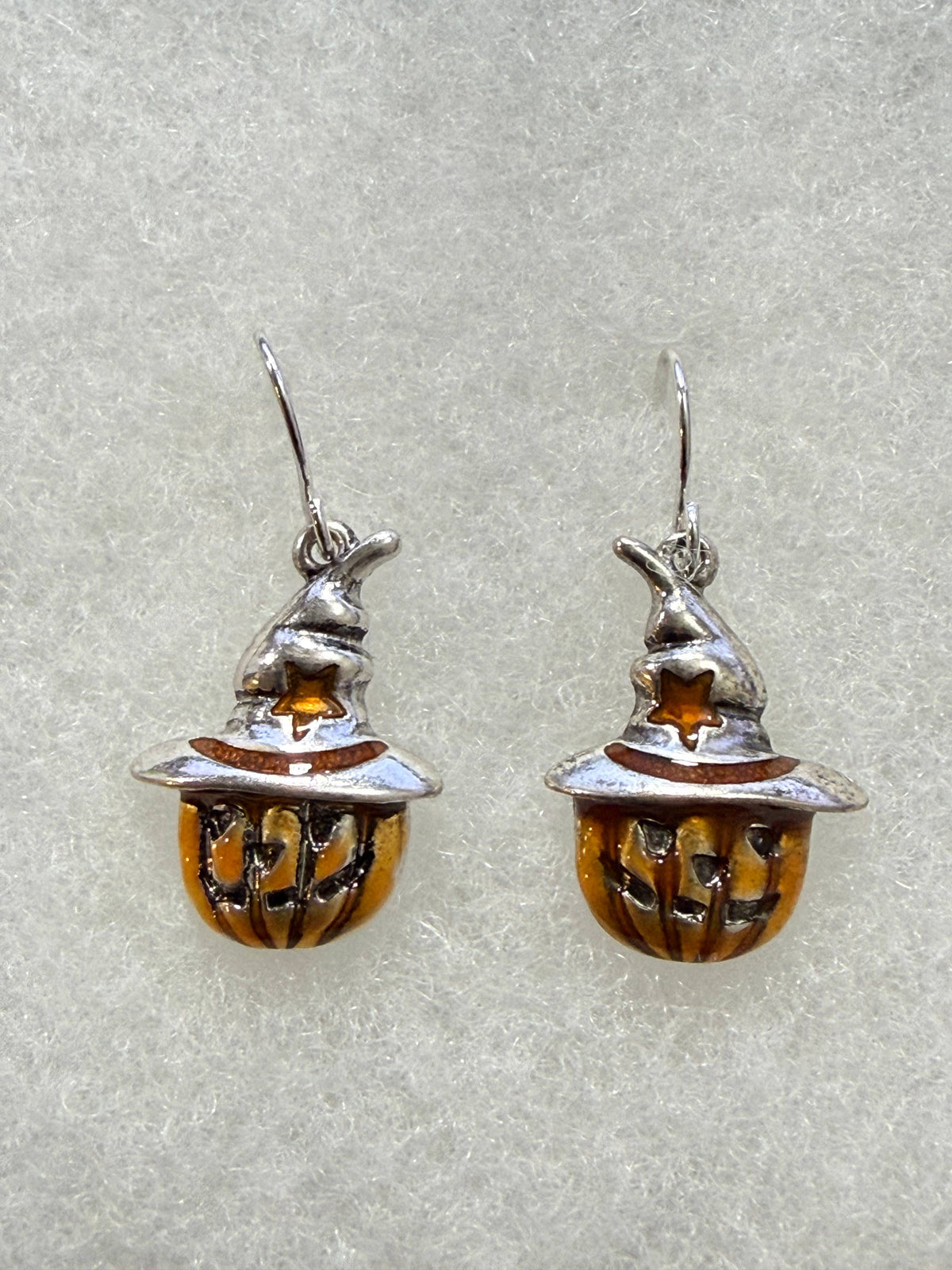 Orange jack-o-lantern earrings wearing silver scarecrow hats
