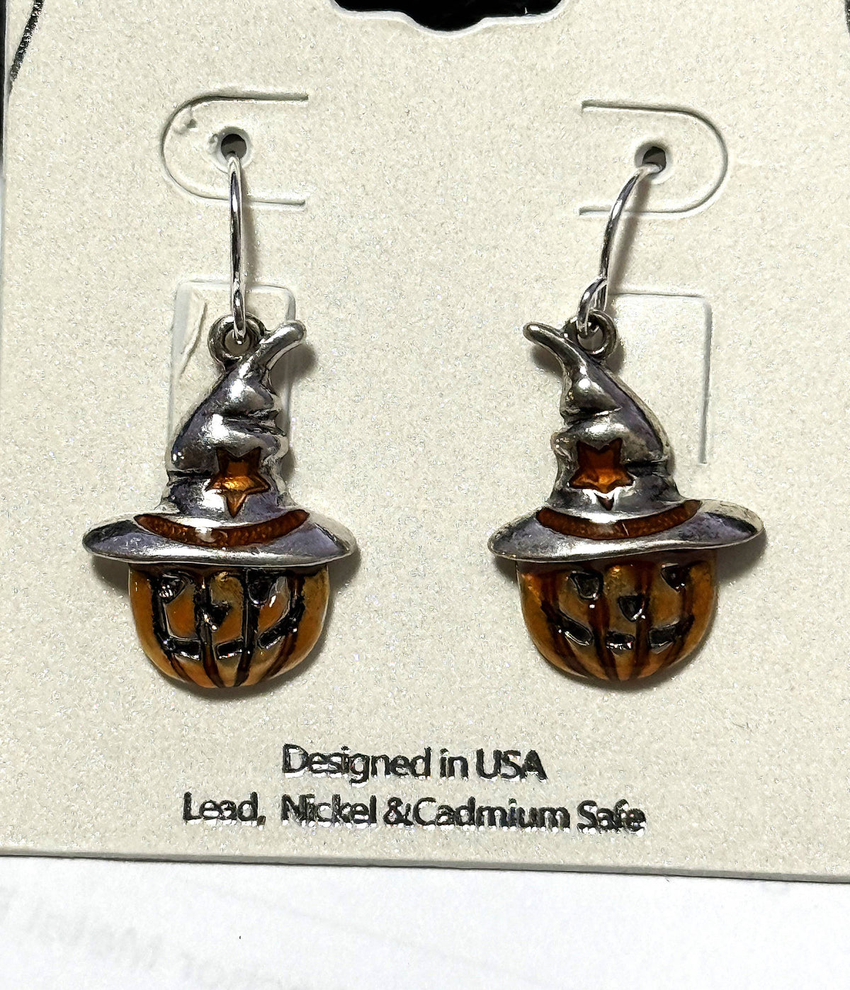 Pumpkin scarecrow earrings on their display card