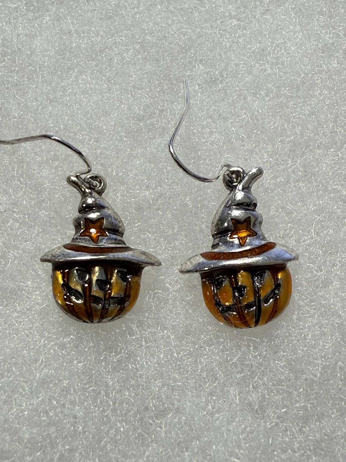 Pumpkin scarecrow earrings, angled view