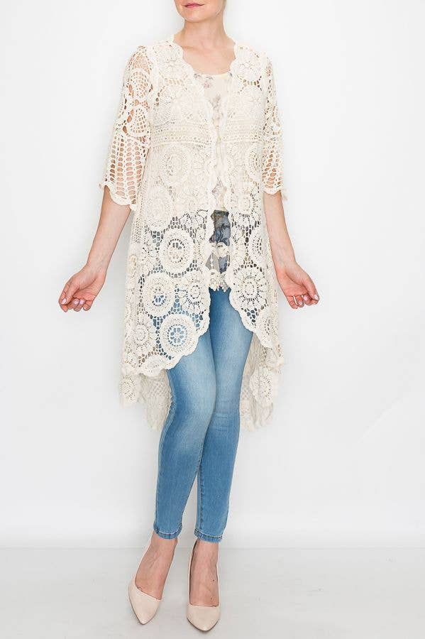 Natural cream high-low crochet duster cardigan over jeans, front view