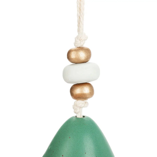 Close-up of the wooden and gold beads above the green Christmas tree bell