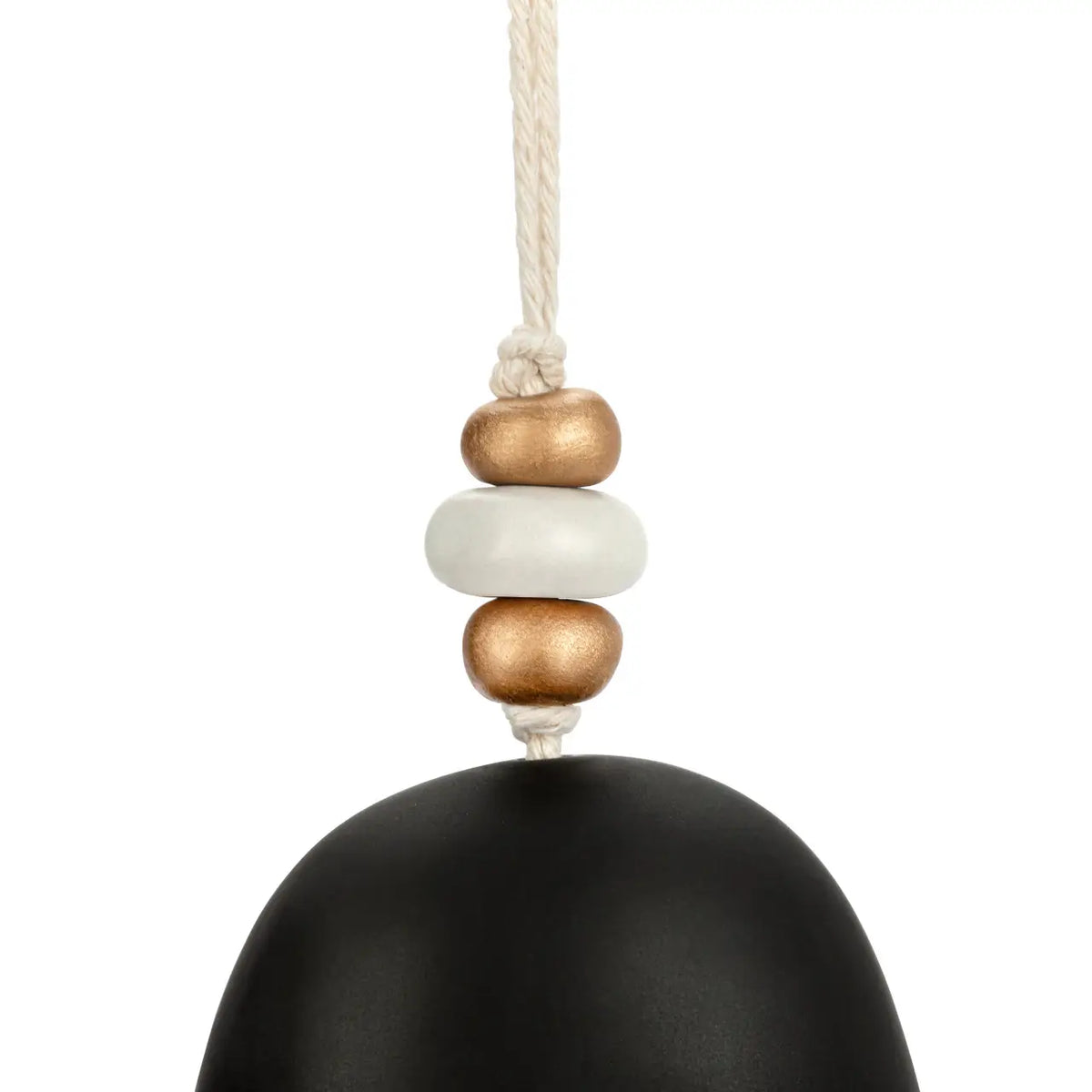 Close-up of the wooden and gold beads at the top of the black nativity holiday bell