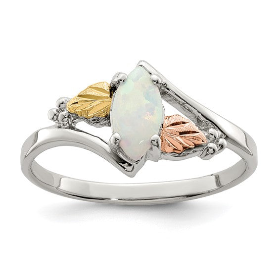 Landstrom's Black Hills sterling silver ring set with a marquise lab created opal, flanked by 12K green gold and rose gold leaves