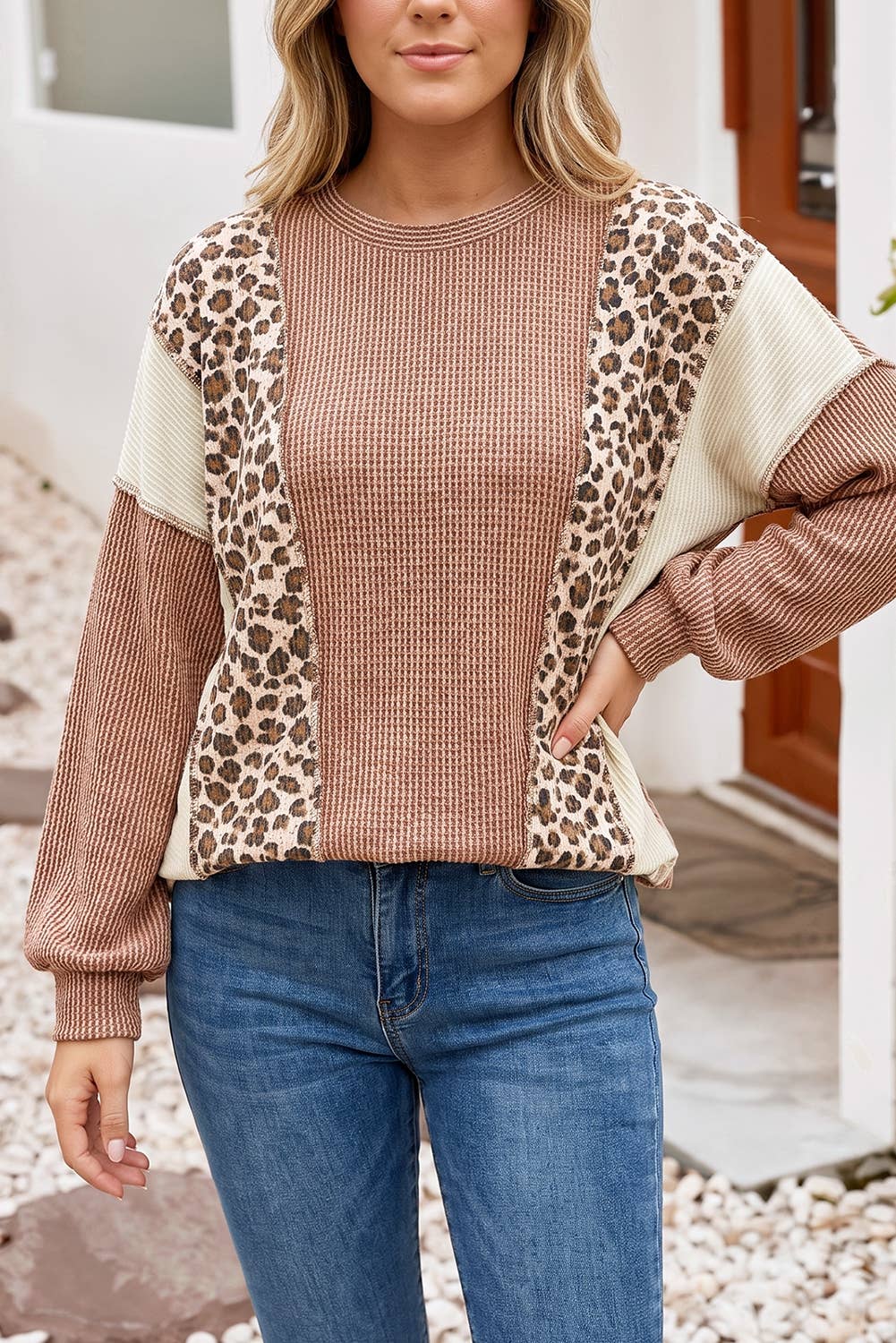 Model wearing the dune leopard print colorblock ribbed knit top with blue jeans, front view