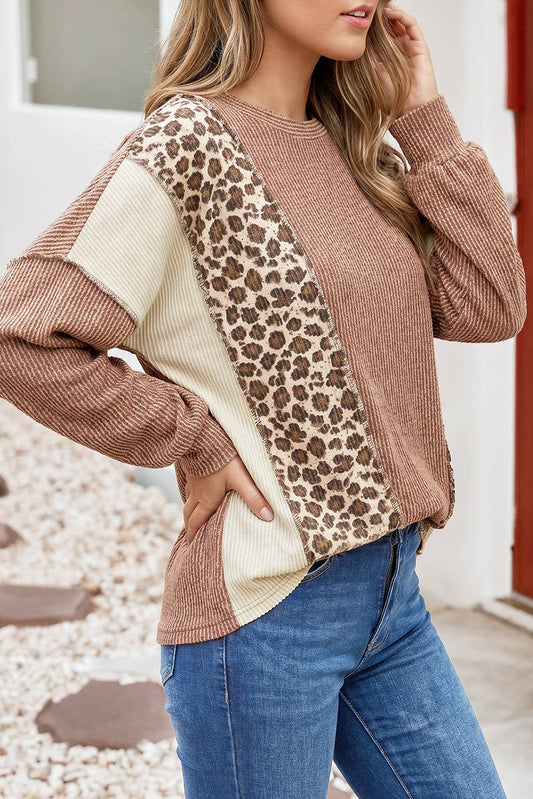 Side view of the dune colorblock top, leopard print and cream panels running down the sleeve and side seam