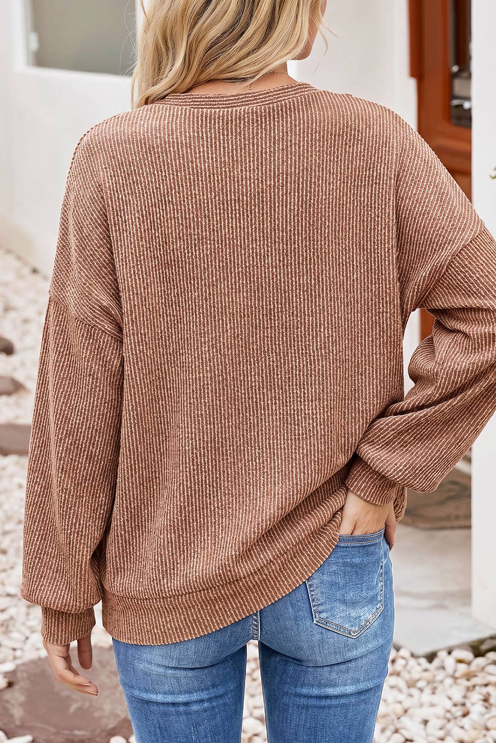 Back view of the dune ribbed knit top, plain rib with long sleeves and dropped shoulders