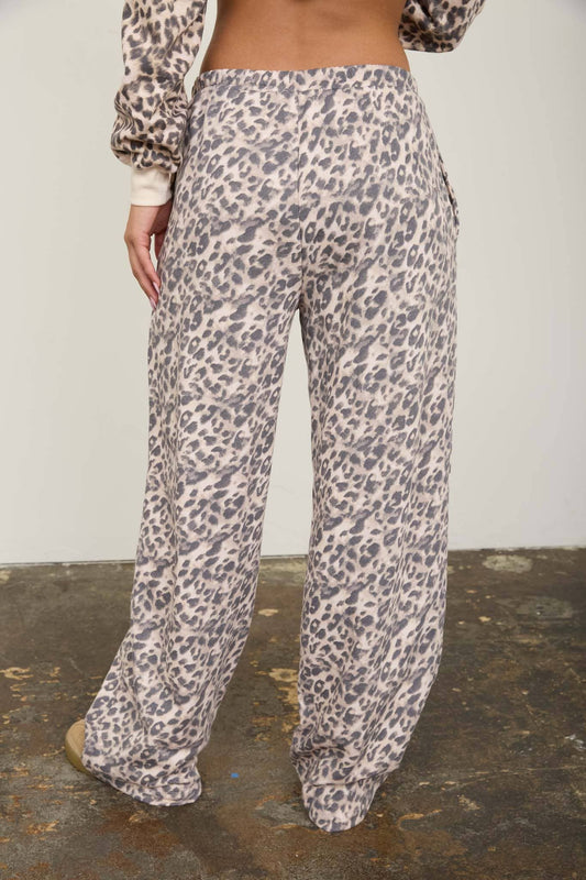 Three quarter view of the leopard lounge pants showing the high elastic waist and the drawstring tie