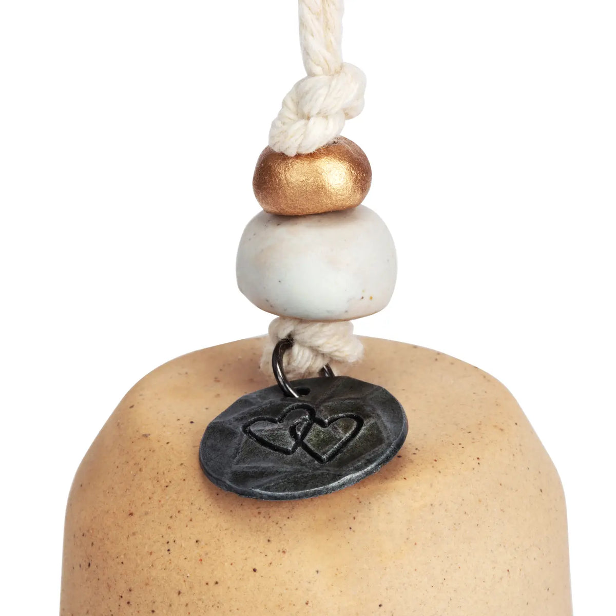 Close-up of the metal medallion tag on the Mini Inspired Bell cord