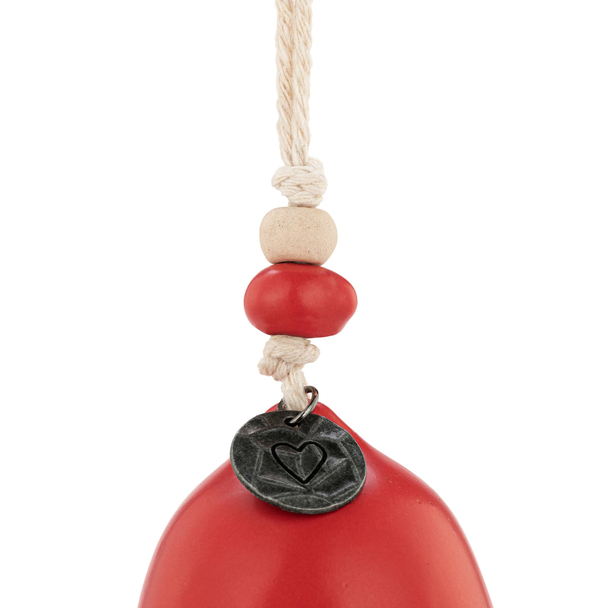 Close-up of the red Believe holiday bell with its metal medallion