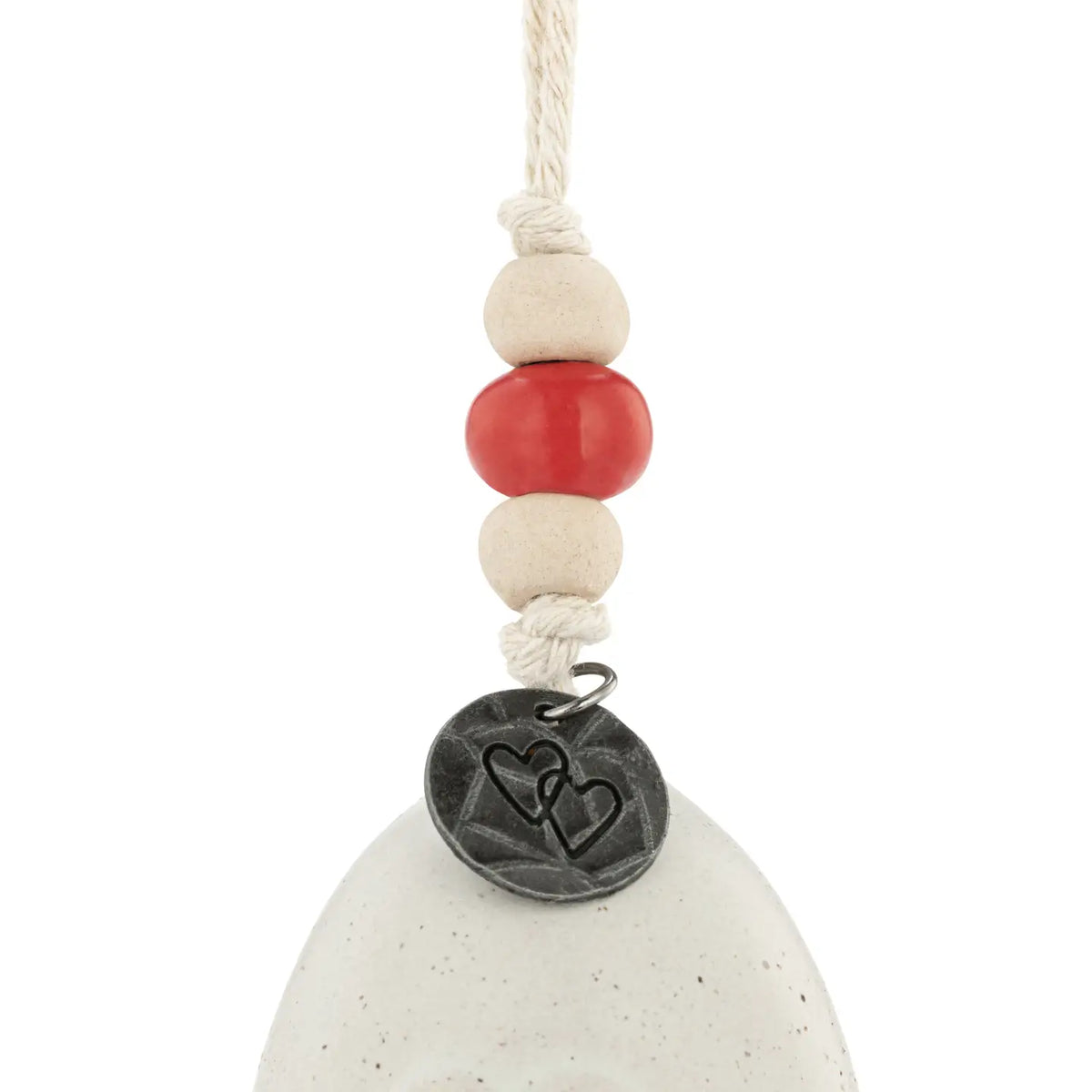 Close-up of the white Love holiday bell with red bead and medallion