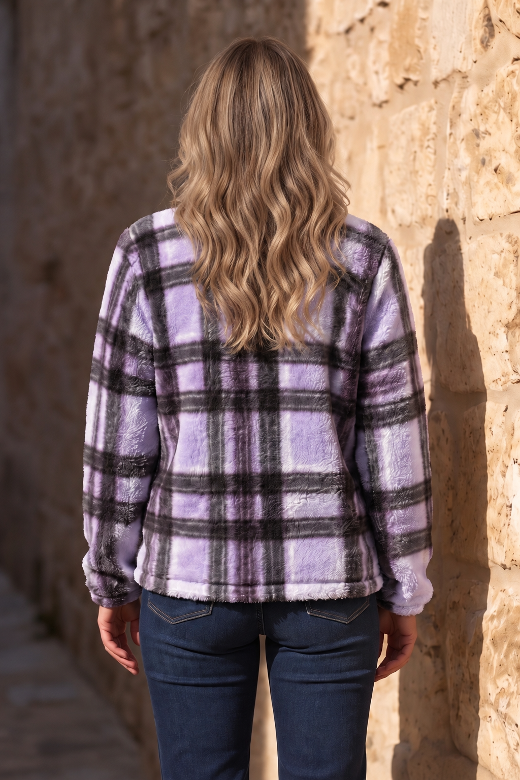 Back view of the violet plaid teddy zip-up jacket worn with jeans