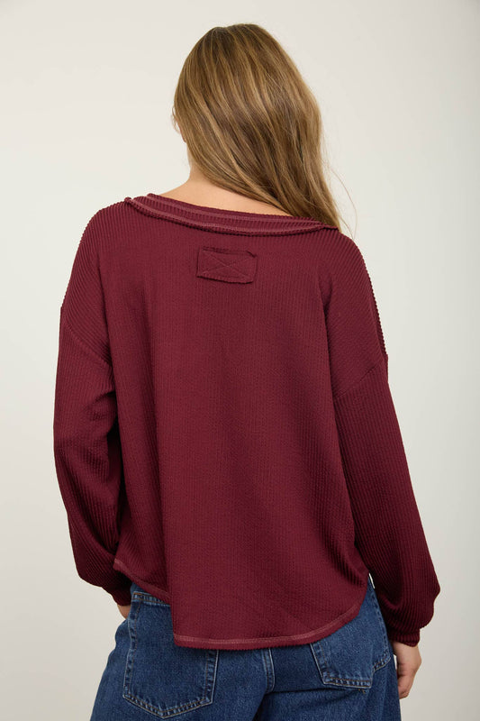 Back view of the burgundy waffle knit top showing the drop shoulder and the raw finished hem