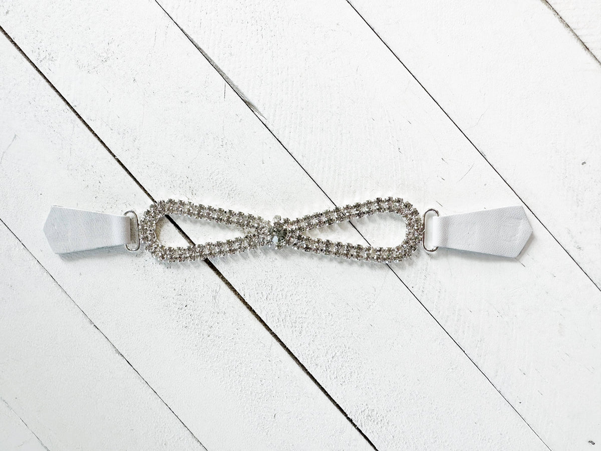 Open view of the rhinestone loop clip and white leather grip tabs