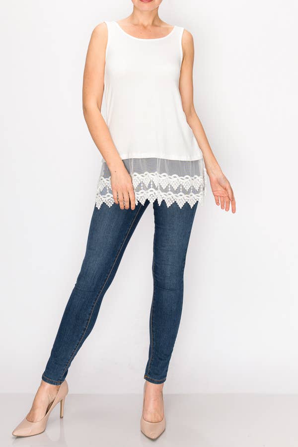 Model wearing an ivory relaxed tank with a floral lace hem, jeans and heels, front view
