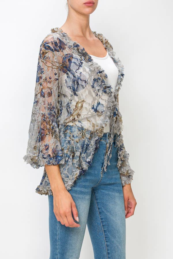 Angled view of the sheer floral lace cardigan showing the ruffle edges and front ties
