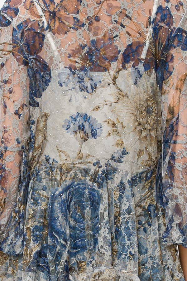 Close-up of the blue, cream and gold floral lace fabric