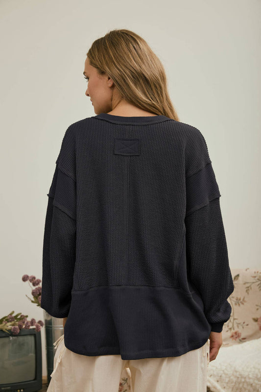 Back view of the charcoal ribbed knit top
